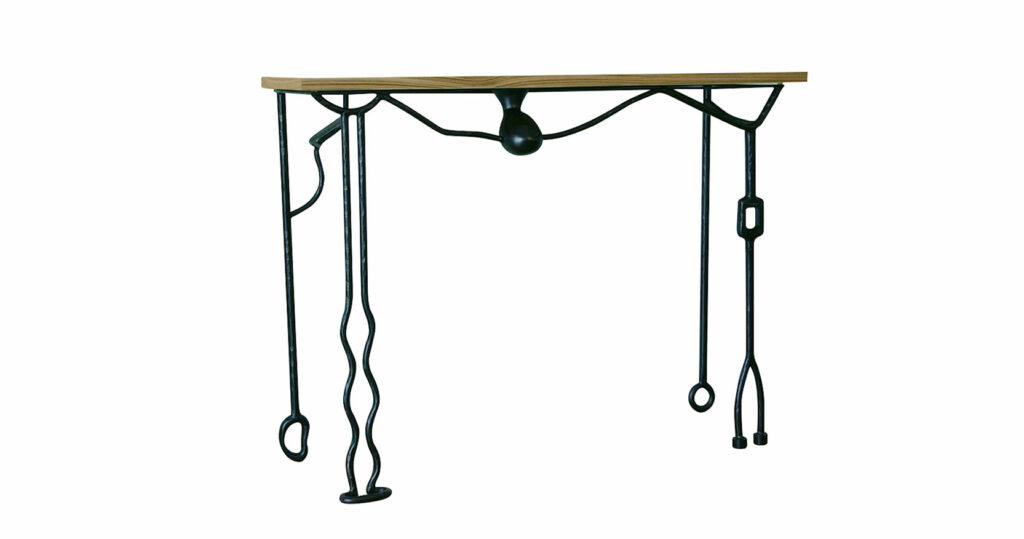Elizabeth Garouste, graphic console table with black carved wrought iron legs of different shapes, a round shape in black bronze that descends from the caramel-colored wooden top