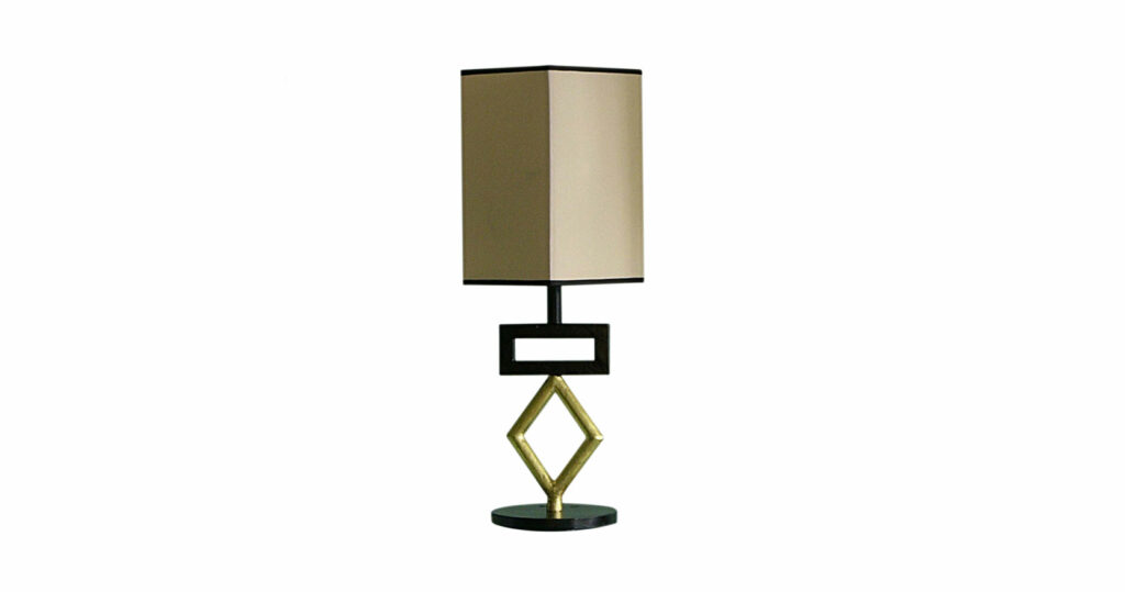 Elizabeth Garouste, lamp in black and gold wrought iron, a gold diamond then a black rectangle on a circular base, beige rectangular lampshade edged with a black braid