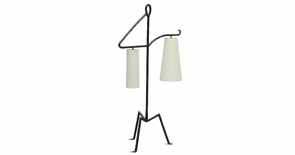 Elizabeth Garouste, sculptural standing lamp in black wrought iron, with 3 feet at acute angles, a vertical rod, and two long horizontal arms with two large white lampshades of different sizes and shapes