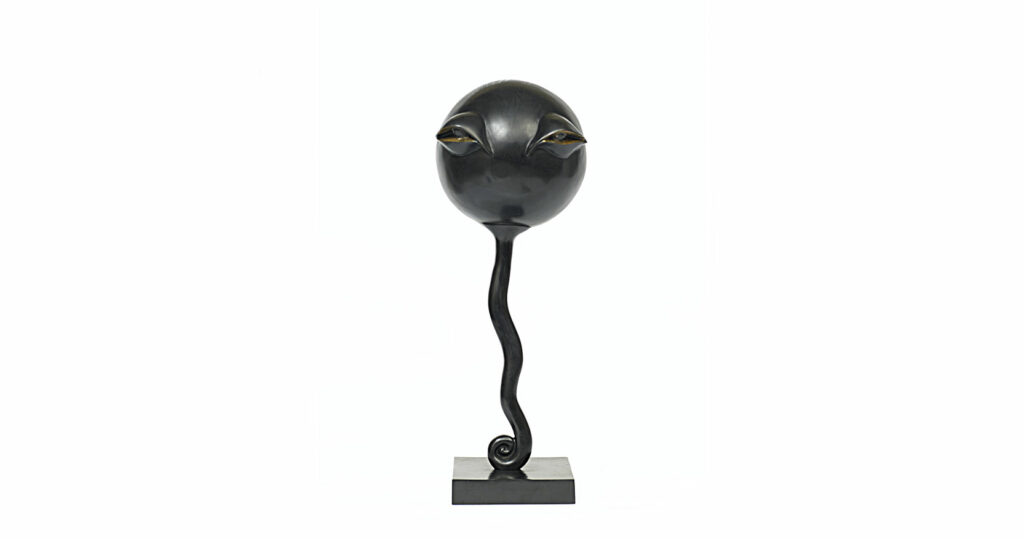Garouste Bonetti, high lamp-sculpture in black bronze, square base, a long curvy neck, surmounted by a face which ressembles E T