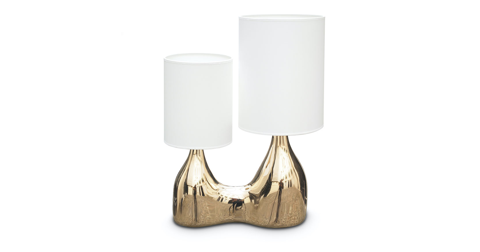 Matt Sindall lamp sculpture in polished bronze. Two lamp bases are fused together like a pair of different sized bottles each with a white cylindrical lampshade, their sizes corresponding to the base.