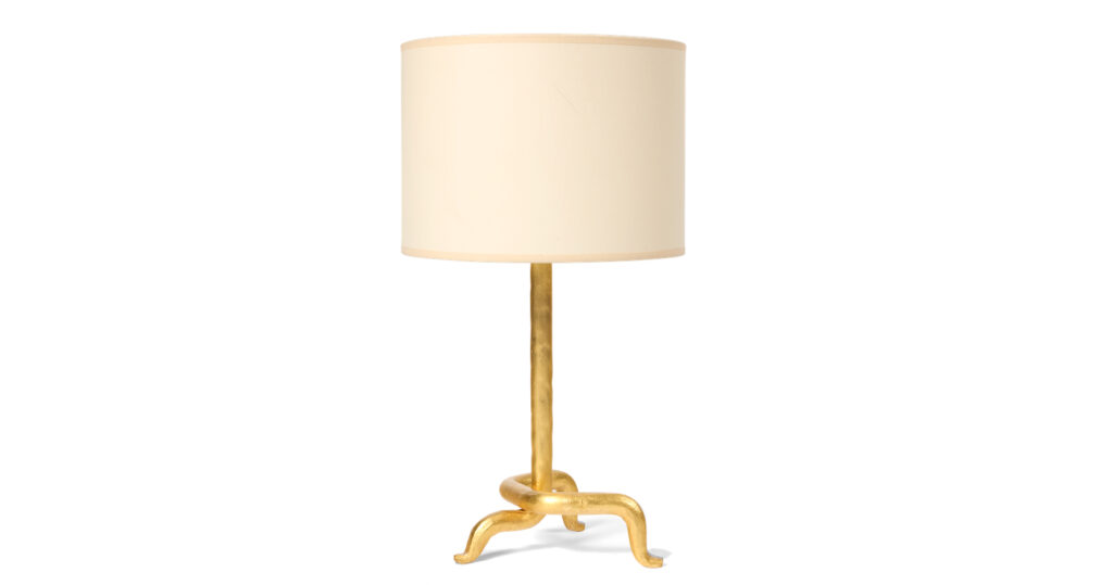 lamp by Mattia Bonetti, with a central rod separating downwards into a tripod, all in wrought iron covered with gold leaf, with a round beige lampshade